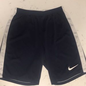 Dark blue and white sided Nike gym shorts.